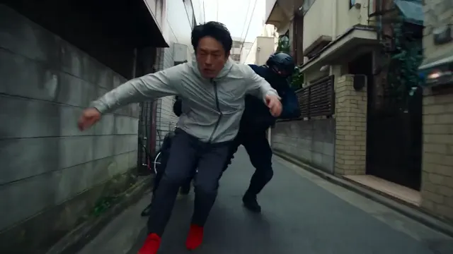 Runner between closely spaced buildings in a narrow city alley