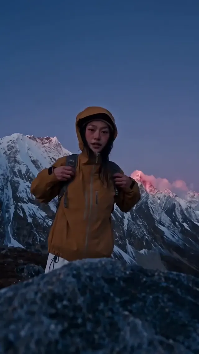 Traveler among snowy mountain peaks in a tall portrait composition